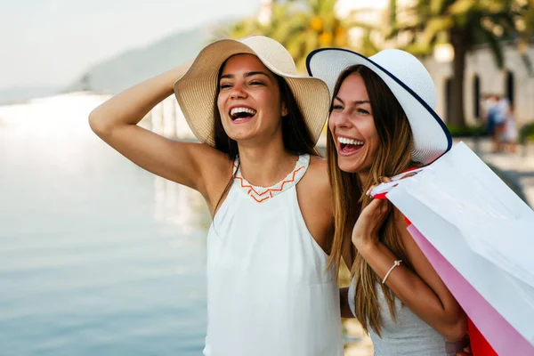 Luxurious life for two beautiful women walking and shopping on summer vacation. People travel fun concept.