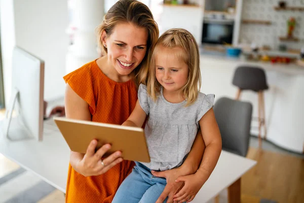 Digital device technology family online education concept. Happy young family with digital devices at home.