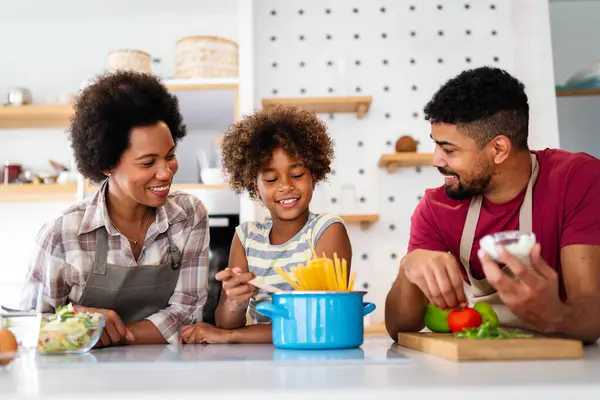 stock image Happy african american smiling family preparing healthy food in kitchen, having fun together on weekend