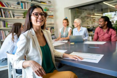 Collaboration and analysis by business people working in office. Successful business women together in corporate office.