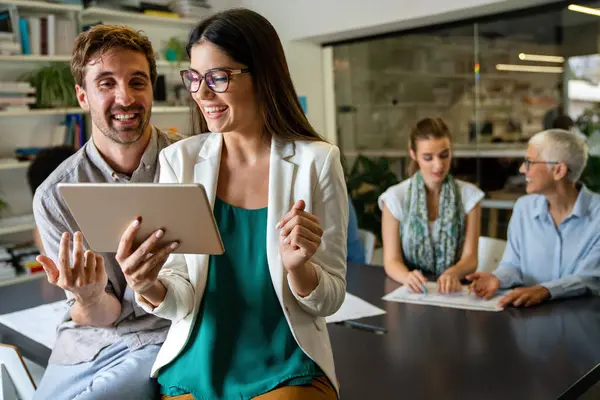 Team of multiethnic creative marketing experts brainstorming during working on advertising strategy for company sharing ideas on conference using technology and wireless connection