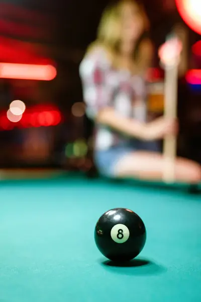8 Ball from pool or billiards on a billiard table. People entertainment game fun concept