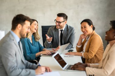 CEO businessman leader with diverse coworkers team, executive managers group at meeting. Multicultural professional businesspeople working together on research plan in boardroom. clipart