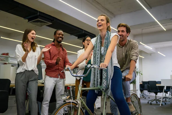 Carefree diverse office workers having fun during work break, employees coworkers feeling free laughing playing together