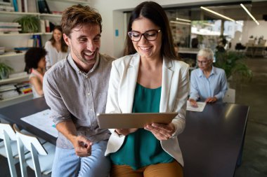 Group of happy startup business people having fun and chatting at workplace office. Teamwork fun office people concept.