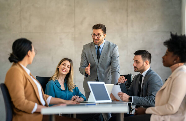 Formal IT business startup company meeting. Team leader discussing and brainstorming new approaches and ideas with colleagues. Startup business and entrepreneurship concept.