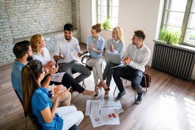Çeşitli çalışanlar, beyin fırtınası sırasında ofiste toplanarak yeni projeleri için yeni fikirleri tartıştılar. Çok ırklı iş arkadaşları toplantı odasında toplanıp toplantıda fikir alışverişinde bulundular..