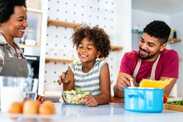 stock image Happy african american parents and child having fun preparing healthy food in kitchen. Family happiness fun concept