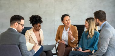 Çeşitli iş adamları modern bir ofiste toplantı sırasında çizelgeleri tartışıyor. Girişim, mali istatistikler, takım çalışması kavramı