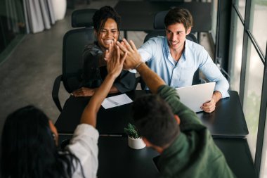 Bir grup çok ırklı, çeşitli iş adamları finans şirketleri için fikir ve çözümleri tartışmak üzere bir toplantı yapıyorlar. Mutlu iş adamları büyüme ve başarı elde etmek için birlikte çalışıyorlar..
