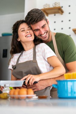 Gizli bileşen aşktır. Güzel genç çift evde boş vakit geçirirken birlikte sağlıklı bir yemek hazırlıyor.