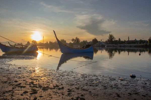 Boat on the beach at sunrise in Aceh province, Indonesia.