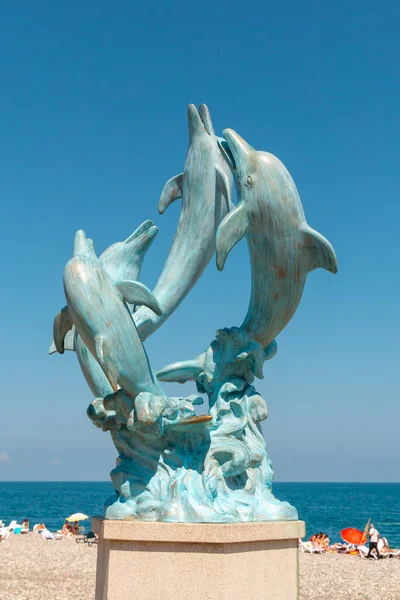 stock image Batumi, Georgia - 30 August, 2022: Dolphin statue on the coast of Batumi. Travel