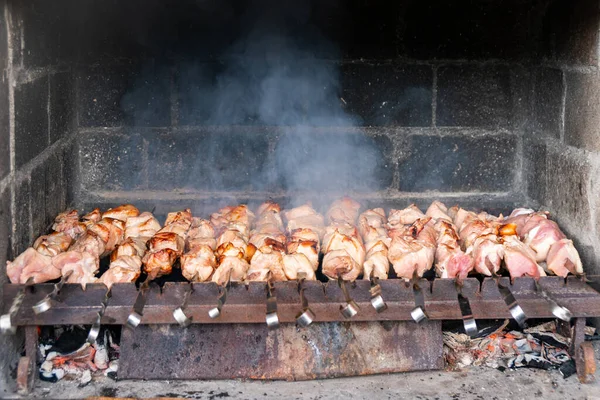 stock image Traditional georgian mtsvadi, grill on the coals with smoke. Shashlik, barbecue