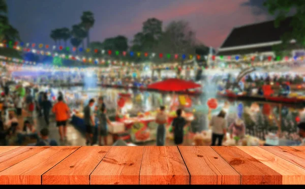 perspective wooden board bar over blurred Thai night market