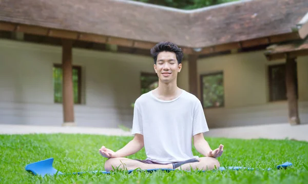 Peaceful Asian Man Man Practicing Yoga Meditation Green Grass Concept — Stock Photo, Image