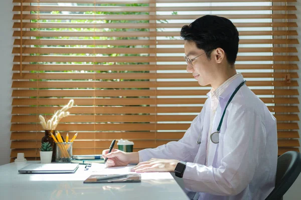 Concentrated Doctor White Medical Coat Writing Medical Report Patient Working — Foto Stock