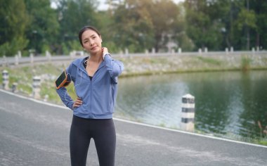 Güzel bir günde parkta koştuktan sonra dinlenen atletik kadın portresi..