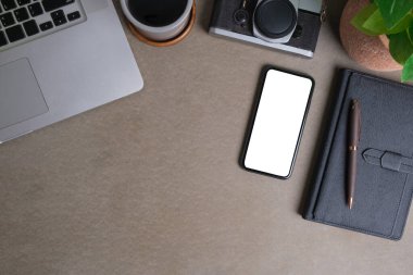 Üst görünüm dizüstü bilgisayar, akıllı telefon ve gri masadaki kamera. Reklam metnin veya bilgi içeriğin için alanı kopyala.
