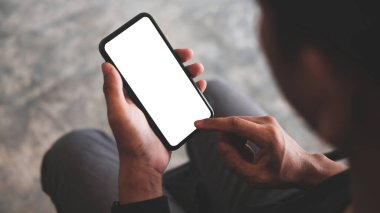 Close up view man holding mock up smart phone. Blank screen for your advertising text.	