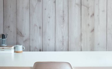 Minimal and simple workplace, Cup of coffee, books and pencil holder on white table. Copy space for text.