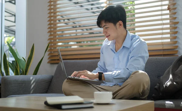 Smiling Asian Man Sitting Couch Working Online Laptop — Stock Photo, Image