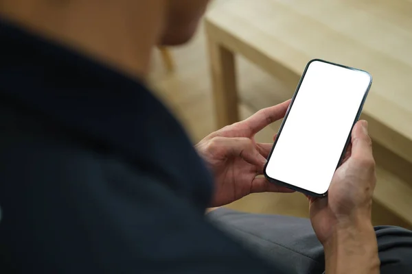 Man holding mock up smart phone. Blank screen for your text message or information content.	