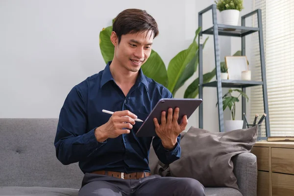 Man Sitting Bright Living Room Using Digital Tablet — стокове фото
