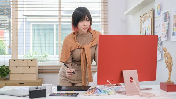 stock image Stylish young female interior designer working on design project in modern studio.