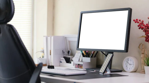 stock image Home office interior with blank computer monitor and office supplies on white table.