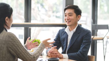 Two professional business colleagues have working, discuss business ideas together.