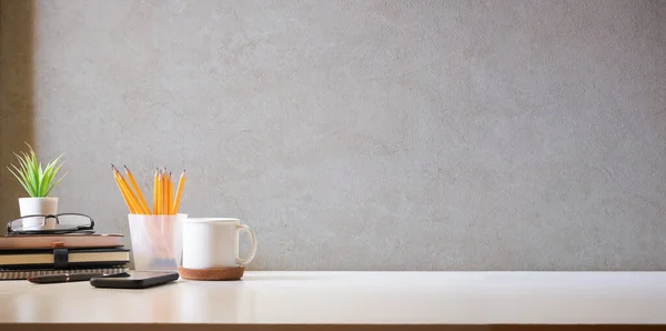 stock image Comfortable workplace with coffee, stationery and houseplant on white table. Home office, copy space.