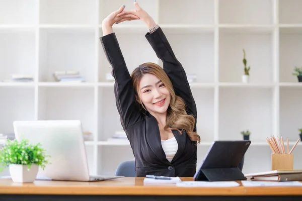 Pretty Young Woman Stretching Her Arms While Relaxing Her Workplace — 스톡 사진