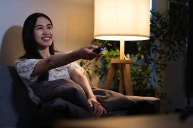 Mutlu milenyum kadınları ve erkekler oturma odasında televizyon seyrediyor.