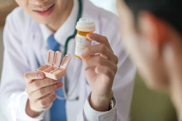 Cropped shot of doctor giving advice, explaining medicine dosage to a patient.