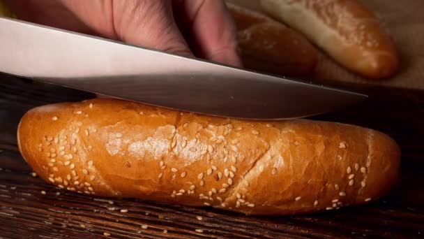 Chefs Hands Slicing Hot Dog Bun Sesame Seeds Kitchen Knife — Stock video