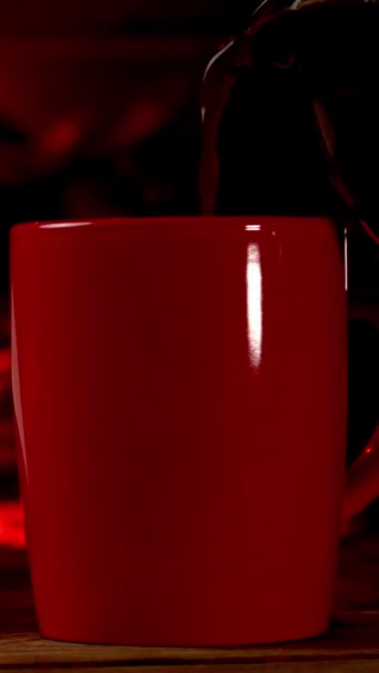Hot Beverage Coffee Tea Poured Red Cup Burning Fireplace Vertical — Stockvideo