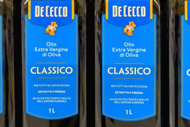 4 Ekim 2023 'te De Cecco klasik İtalyan zeytinyağı süpermarkette satılık cam şişelere bastırıldı. Markette vitrin. Seçici odaklanma. Yumuşak odak.