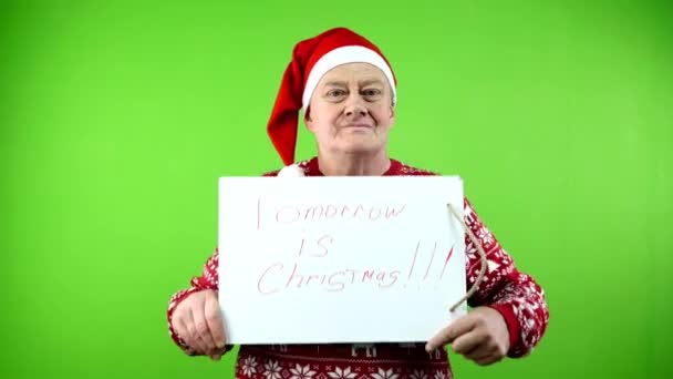 Senior Man Santa Hat Xmas Sweater Holds Inscription Tomorrow Christmas — Stock Video