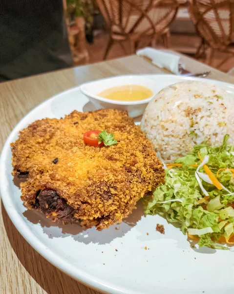 Close-up of the crispy chicken chop set that comes with fried rice and salad.