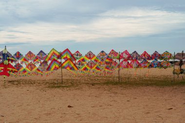 Colourful kites on display for sale at the beach.