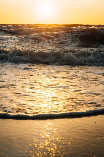 Beautiful view of the sea waves during golden sunset.