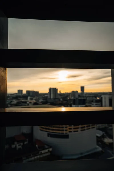 stock image Golden sunlight on the metal gate with  blurry Horizon at sunset in the background.