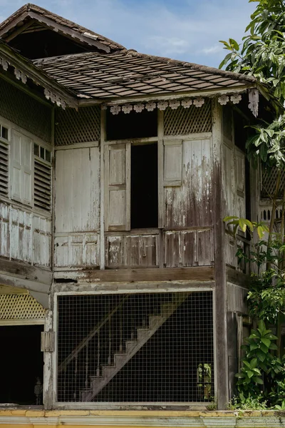 Old weathered wooden house built in 1912 in Kuala Kangsar, Perak, Malaysia.
