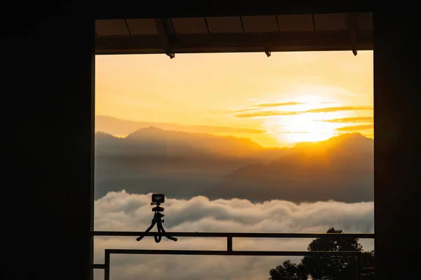 Action camera on tripod capturing sunrise time-lapsed video.