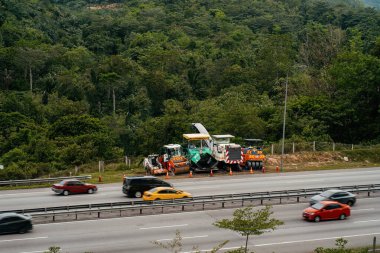 Kajang, Malaysia - March 27, 2022 Road repair machines  parking next to the busy highways.