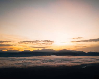 Golden sunrise above the Titiwangsa range mountains surrounded by the sea of clouds in Lenggong, Perak.