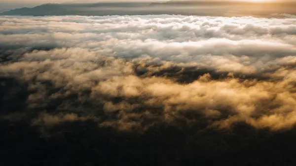白羊座冷宫上空金色日出时的海云 山脉群山丛生 图库图片