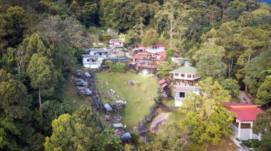 Aerial view of the Hill Resort surrounded by the rainforest in Lenggong during sunrise.