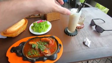 POV. Vietnamese breakfast open air cafe. Coffee bac xiu and bo ne, salad, bread. High quality FullHD footage